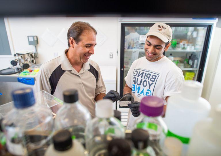 student and professor in the lab